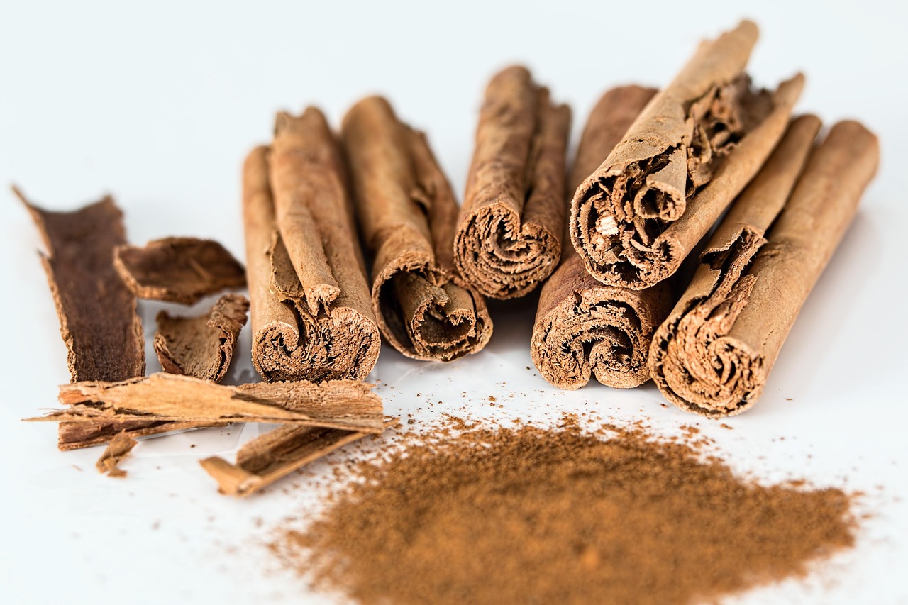 Cinnamon sticks and ground cinnamon powder on white background