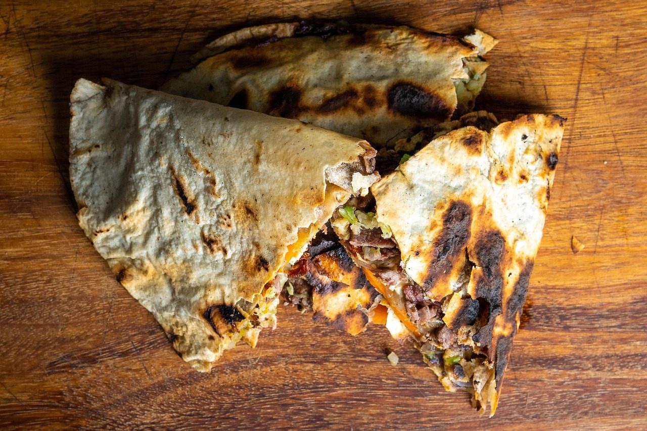 Grilled quesadilla with melted cheese and vegetables